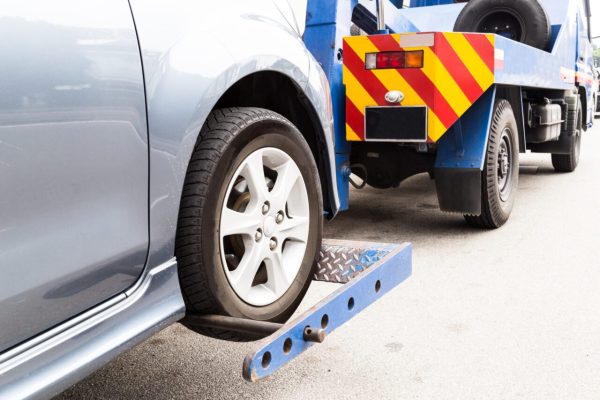 tow-truck-towing-a-broken-down-car-on-the-street-2-e1697119187856.jpg